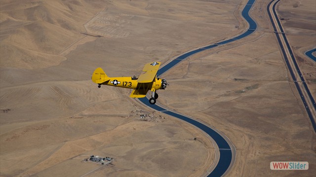 Stearman N54173 and Andreas Hotea cruising over Aquaduct in California